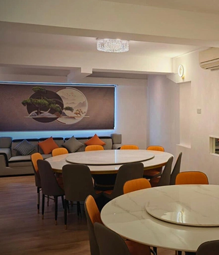 Modern restaurant interior with round marble tables and elegant seating